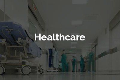 A hospital hallway with a blue hospital bed and the word healthcare on the bottom.