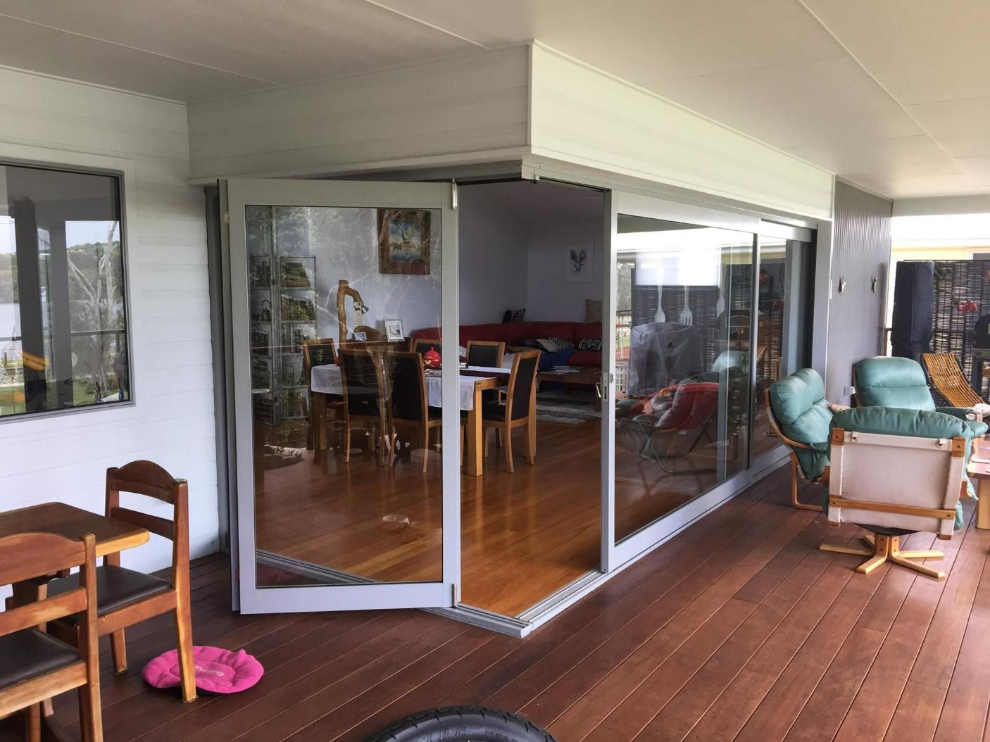 A Living Room With A Large Glass Door And A Wooden Floor — Datco Windows & Doors Pty Ltd In South Murwillumbah, NSW