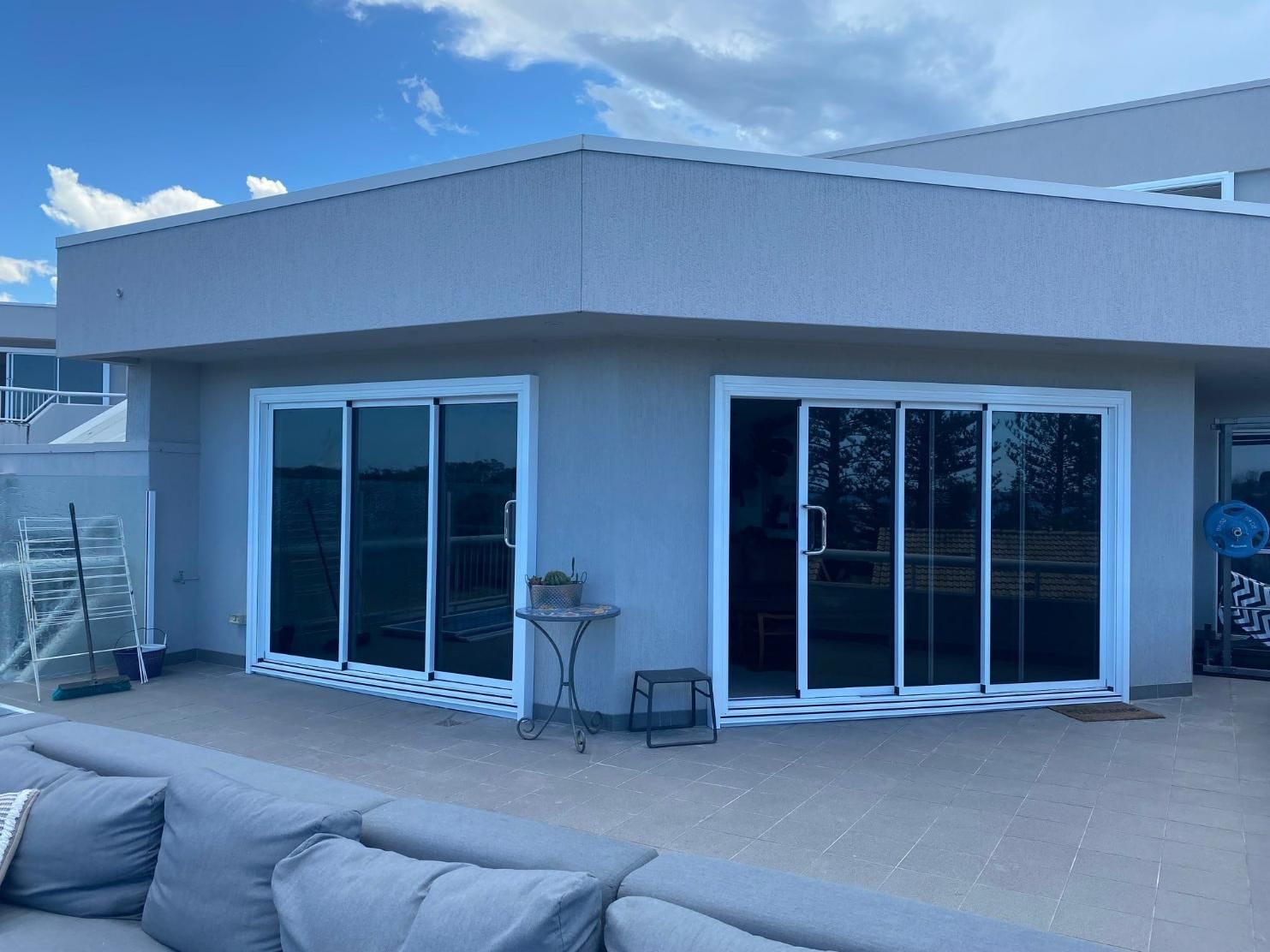 A House With A Lot Of Windows And A Couch In Front Of It — Datco Windows & Doors Pty Ltd In South Murwillumbah, NSW