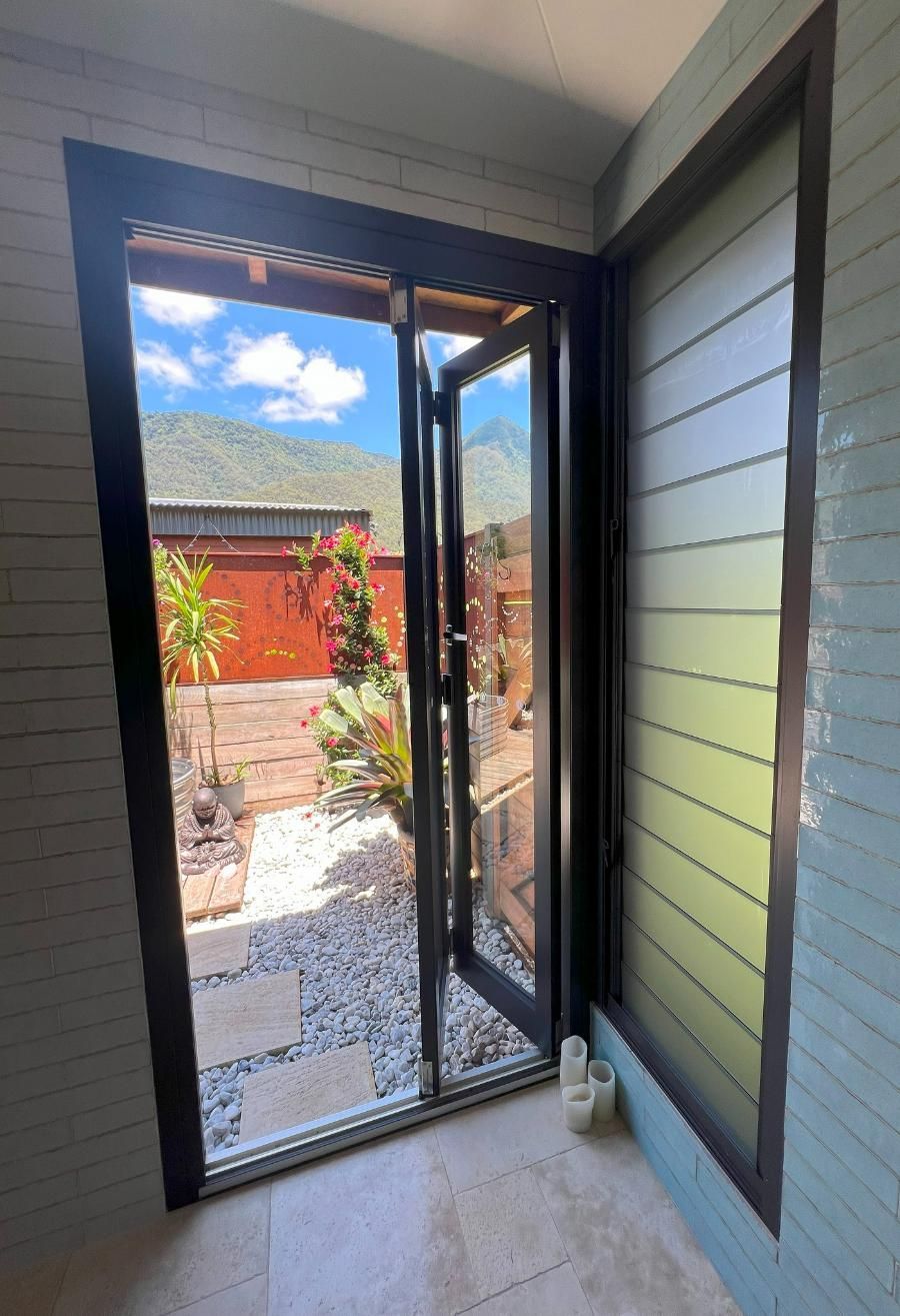 A Room With A Sliding Glass Door Leading To A Garden — Datco Windows & Doors Pty Ltd In Casino, NSW