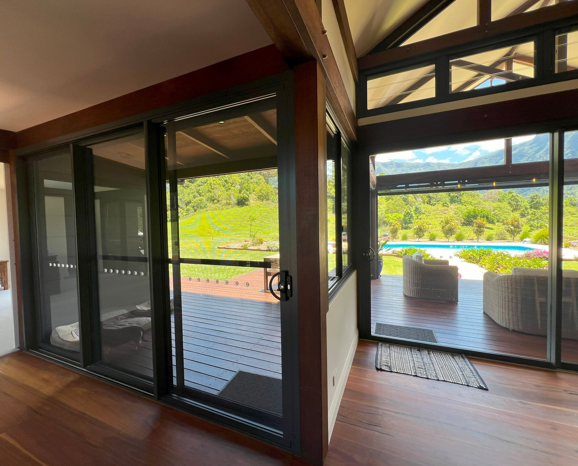 Interior of a Wooden Building With Sliding Glass Doors Open — Datco Windows & Doors Pty Ltd In South Murwillumbah, NSW