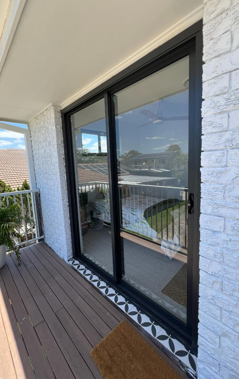There Is A Sliding Glass Door On The Side Of The House — Datco Windows & Doors Pty Ltd In Ballina, NSW