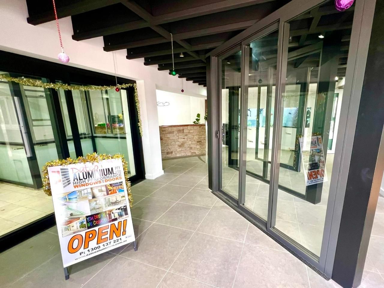 There Is A Sign That Says  Open In The Middle Of A Hallway — Datco Windows & Doors Pty Ltd In Yamba, NSW
