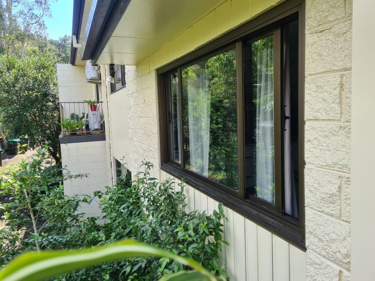 Beige House Exterior With Brown-framed Windows — Datco Windows & Doors Pty Ltd In South Murwillumbah, NSW
