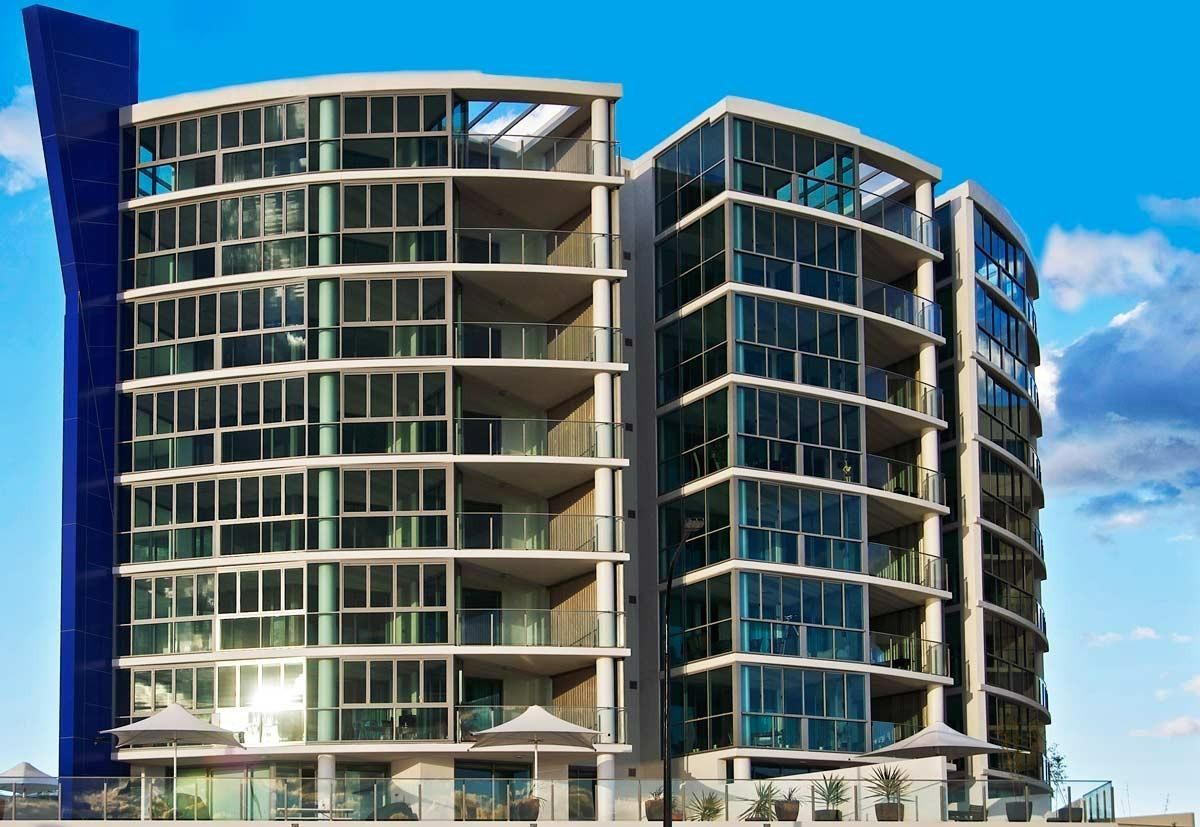 A Tall Building With A Lot Of Windows And Balconies — Datco Windows & Doors Pty Ltd In South Murwillumbah, NSW