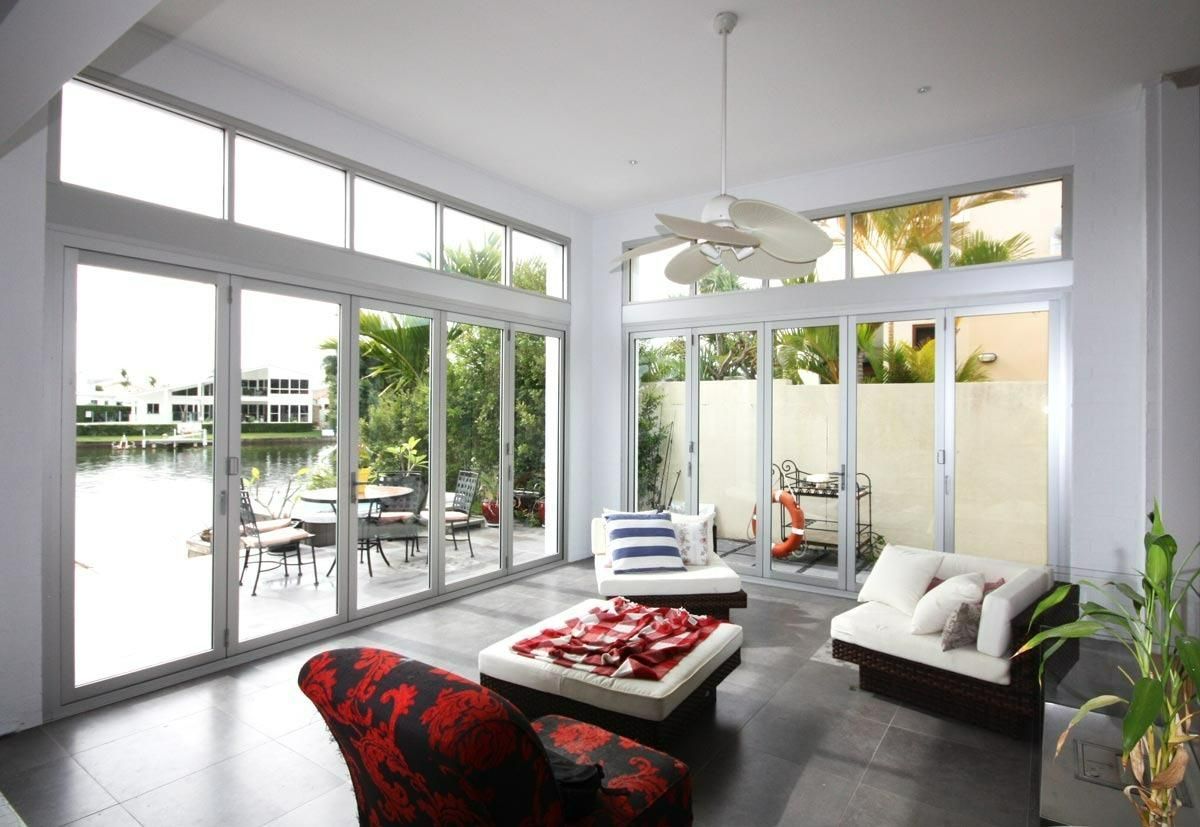 A Sliding Glass Door Is Open To A Porch — Datco Windows & Doors Pty Ltd In Murwillumbah, NSW