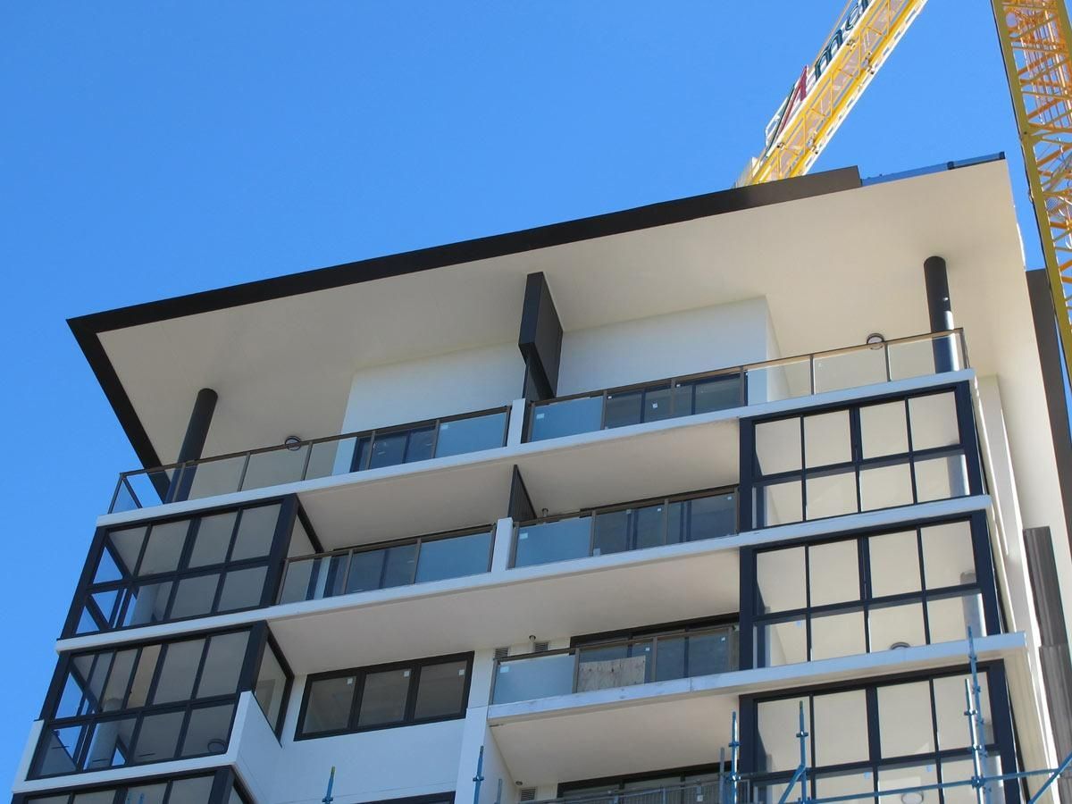 A Tall Building With A Crane On Top Of It — Datco Windows & Doors Pty Ltd In South Murwillumbah, NSW