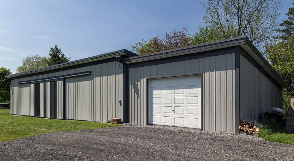 A large gray and black garage with a white garage door.