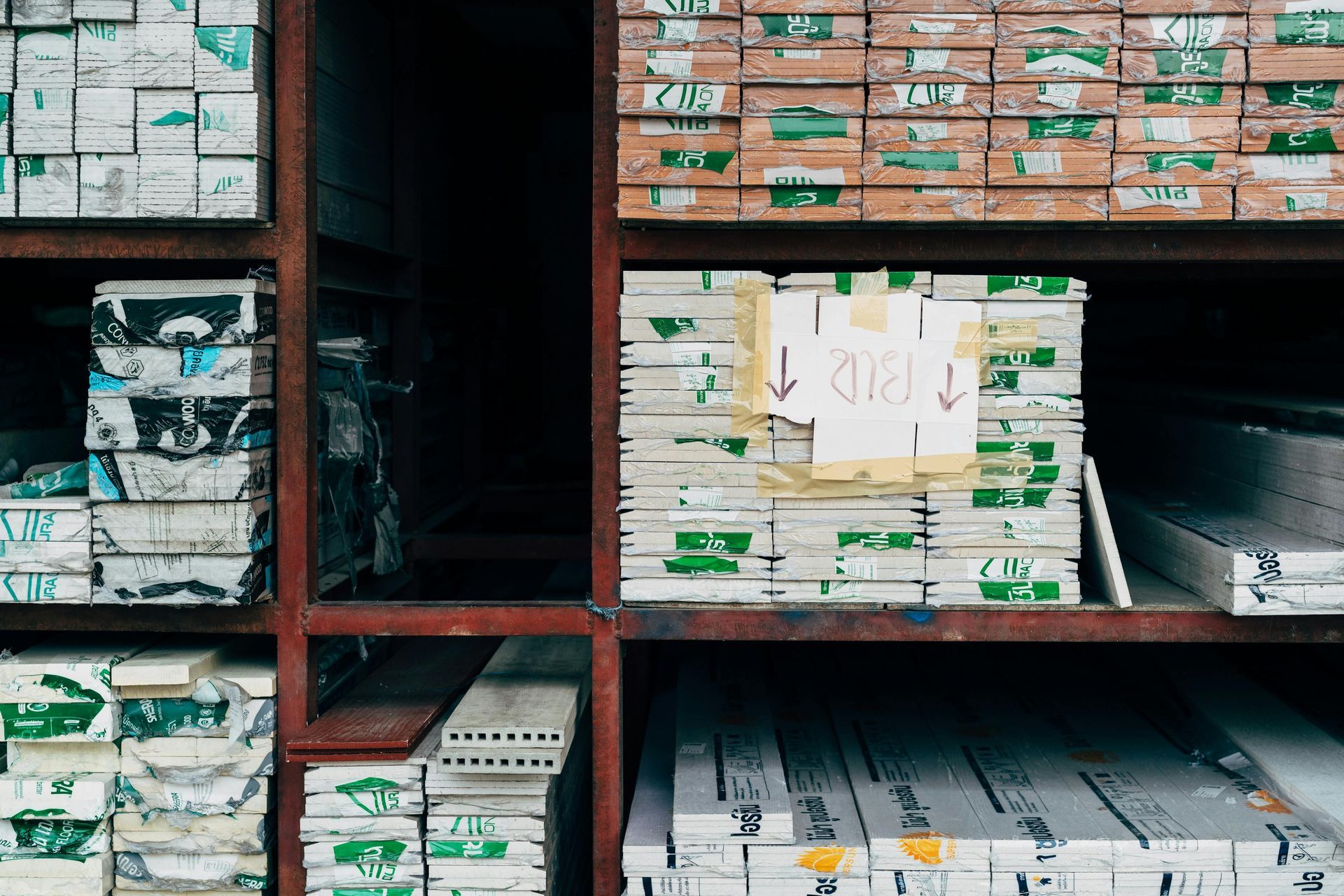 Shelves filled with stacked building materials; various colors and textures.
