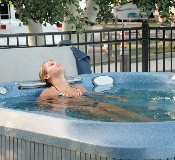 Woman Relaxing on Hot Tub — Livonia, MI — Glenn’s Fireplace & Spa