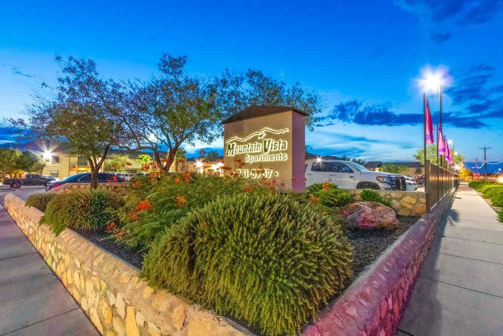 There is a sign in the middle of a garden.