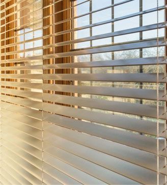 A close up of a window with blinds on it
