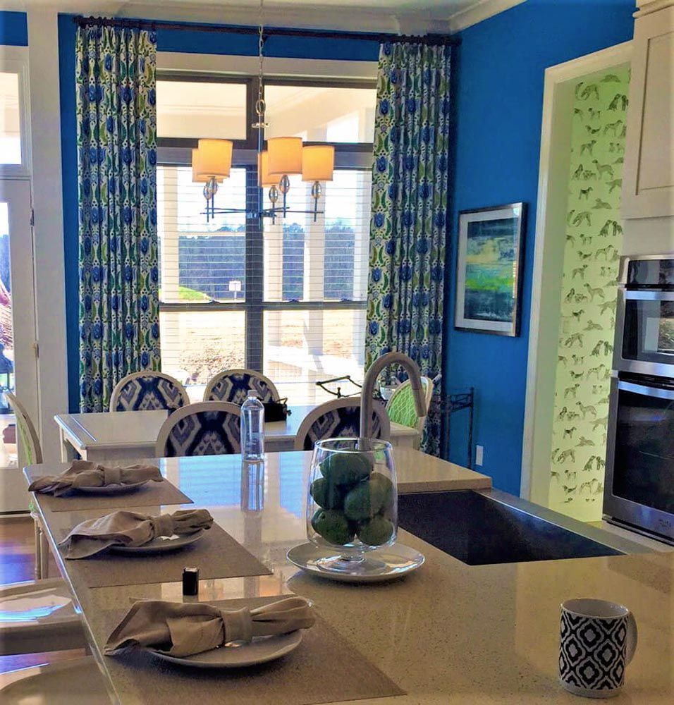 A kitchen with blue walls and a table with plates and napkins on it