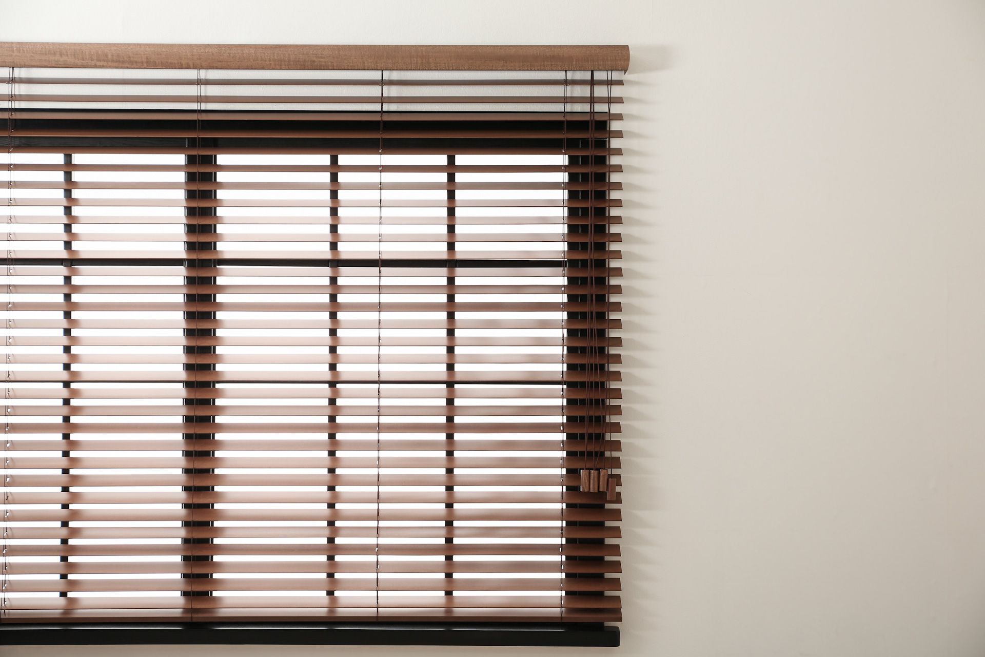 A close up of a window with wooden blinds on it