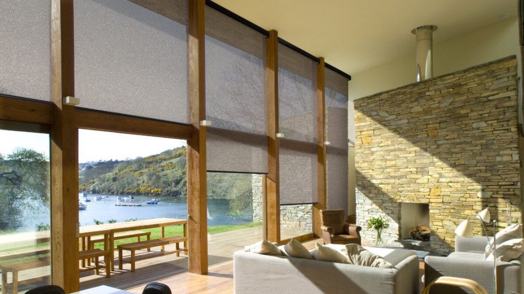 A living room with a lot of windows and a view of a lake