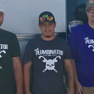 Three men wearing matching dark shirts with 