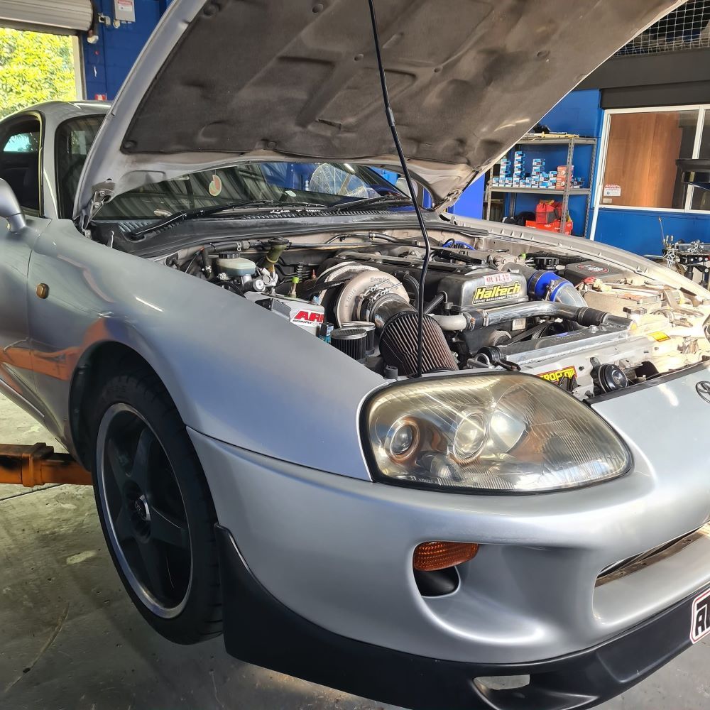 Silver Toyota Supra With Its Hood Open in a Mechanic Shop — Wellers Automotive & Performance in Urangan, QLD