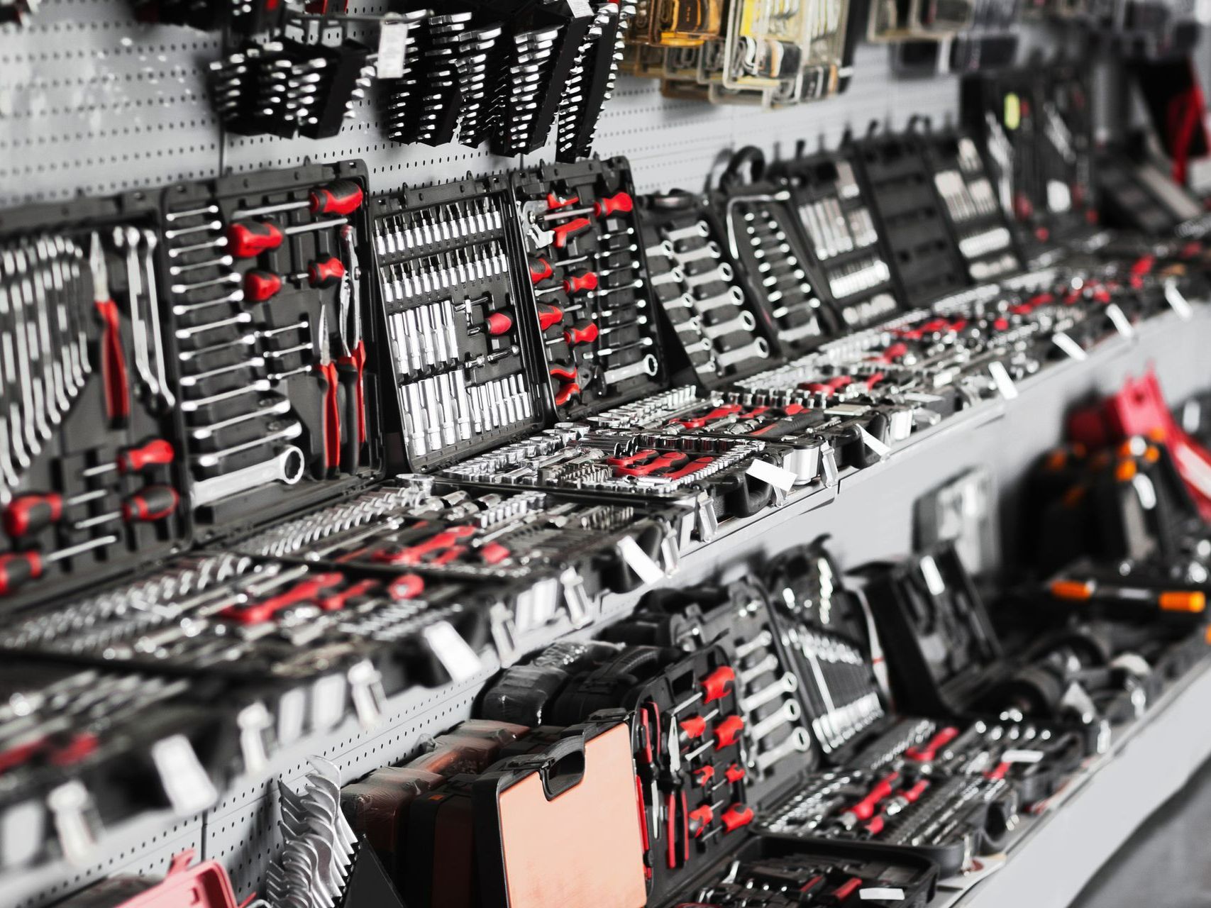 Tool sets displayed on store shelves; various sizes, black and red handles.