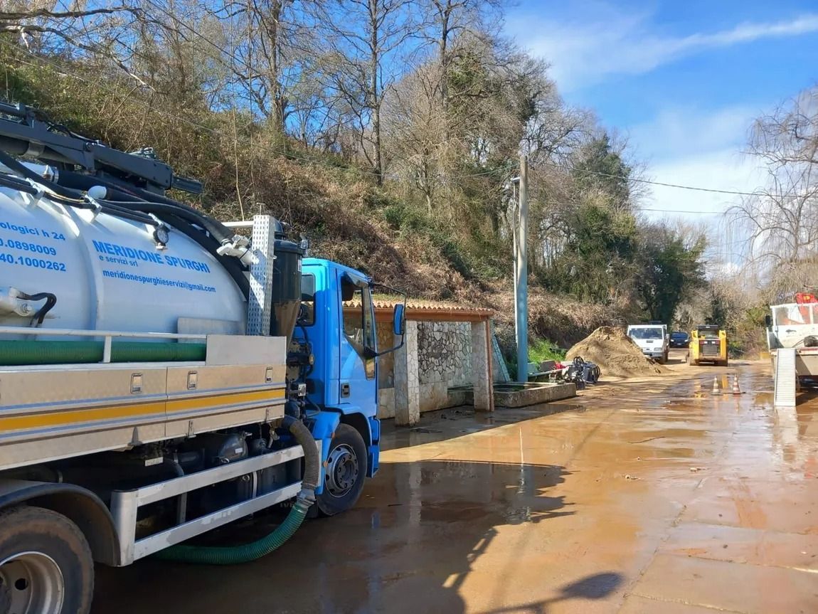 Autocisterna blu su strada fangosa, cantiere.