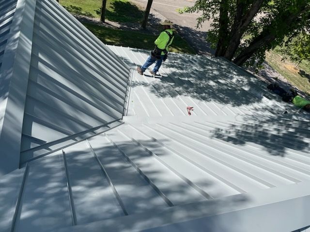 A man is standing on the roof of a building.