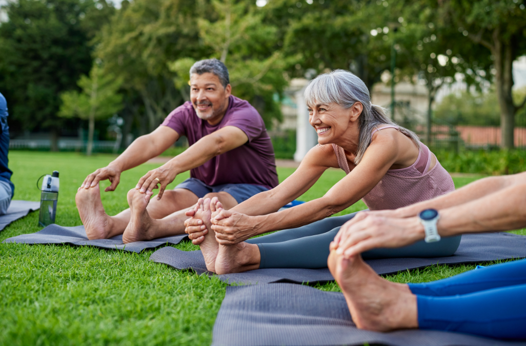 Person in therapy, covering face. Therapist writes notes on a clipboard, indoor setting.