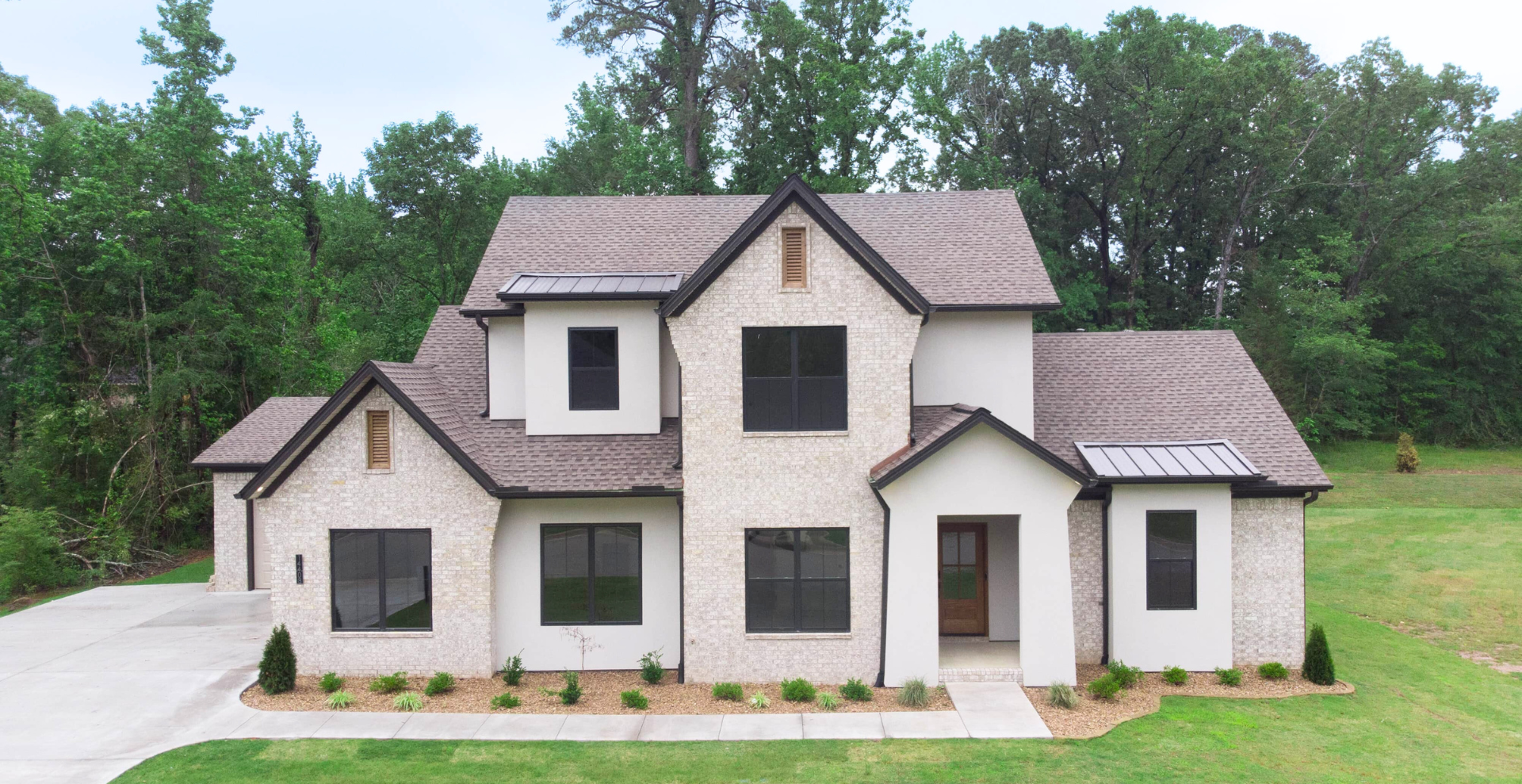 new construction home that is two story and lighter exterior colors. full of windows for natural light