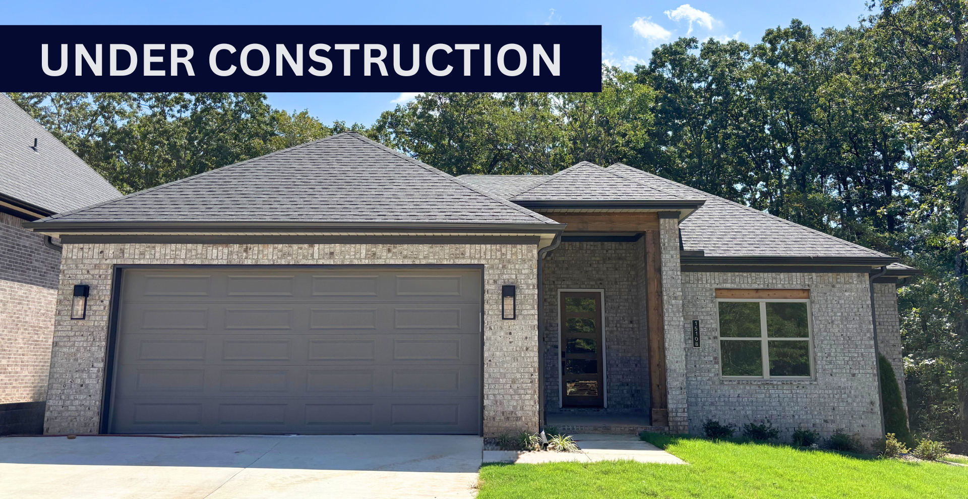 new construction home that is two story and lighter exterior colors. full of windows for natural light