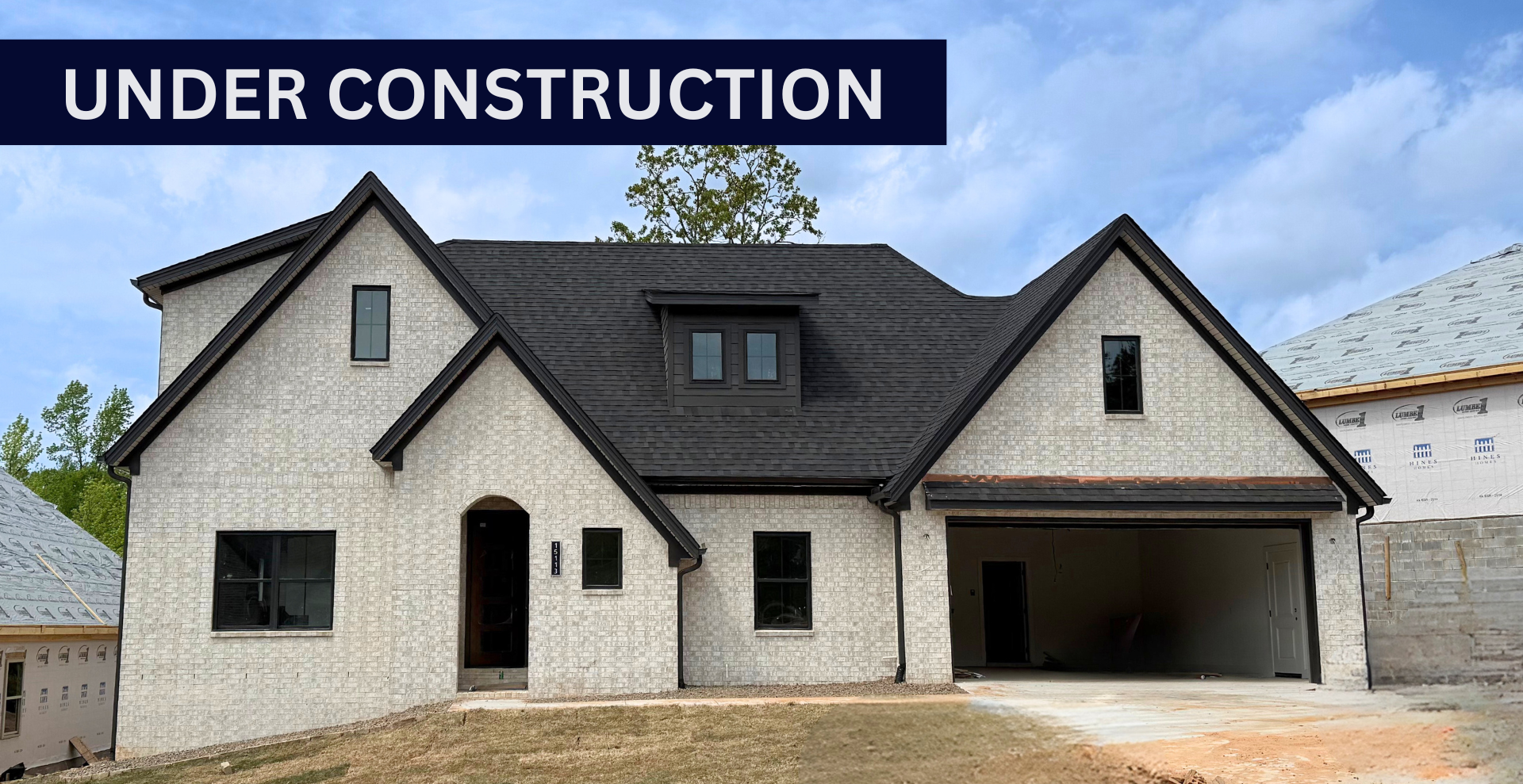 new construction home that is two story and lighter exterior colors. full of windows for natural light
