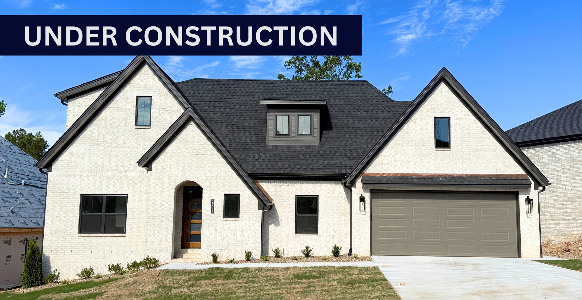 new construction home that is two story and lighter exterior colors. full of windows for natural light