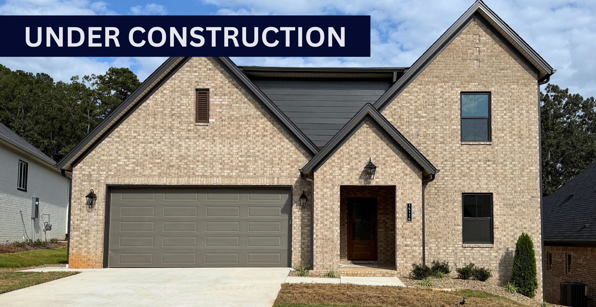 new construction home that is two story and lighter exterior colors. full of windows for natural light