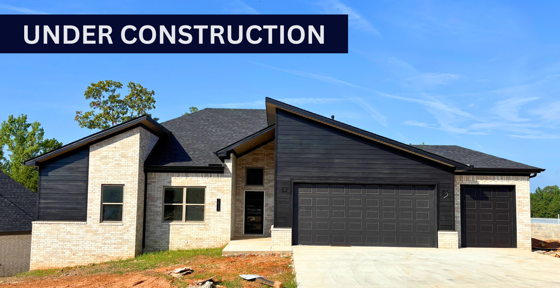 new construction home that is two story and lighter exterior colors. full of windows for natural light