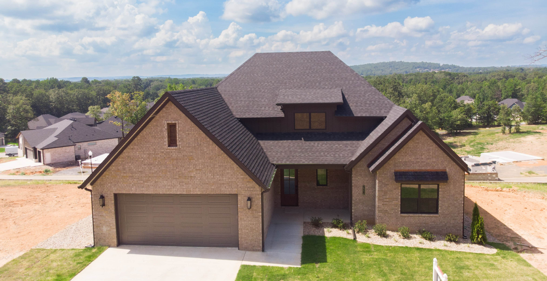 new construction home that is two story and lighter exterior colors. full of windows for natural light