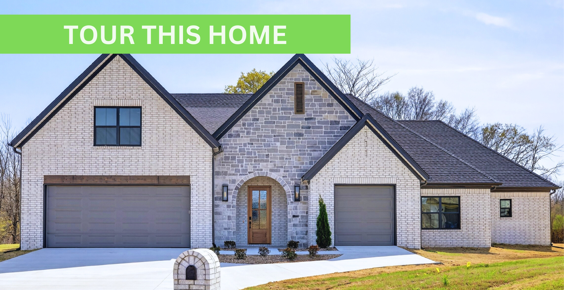 Simple custom home built by hines homes with dark brick and a white accent wall out front with a curved front porch