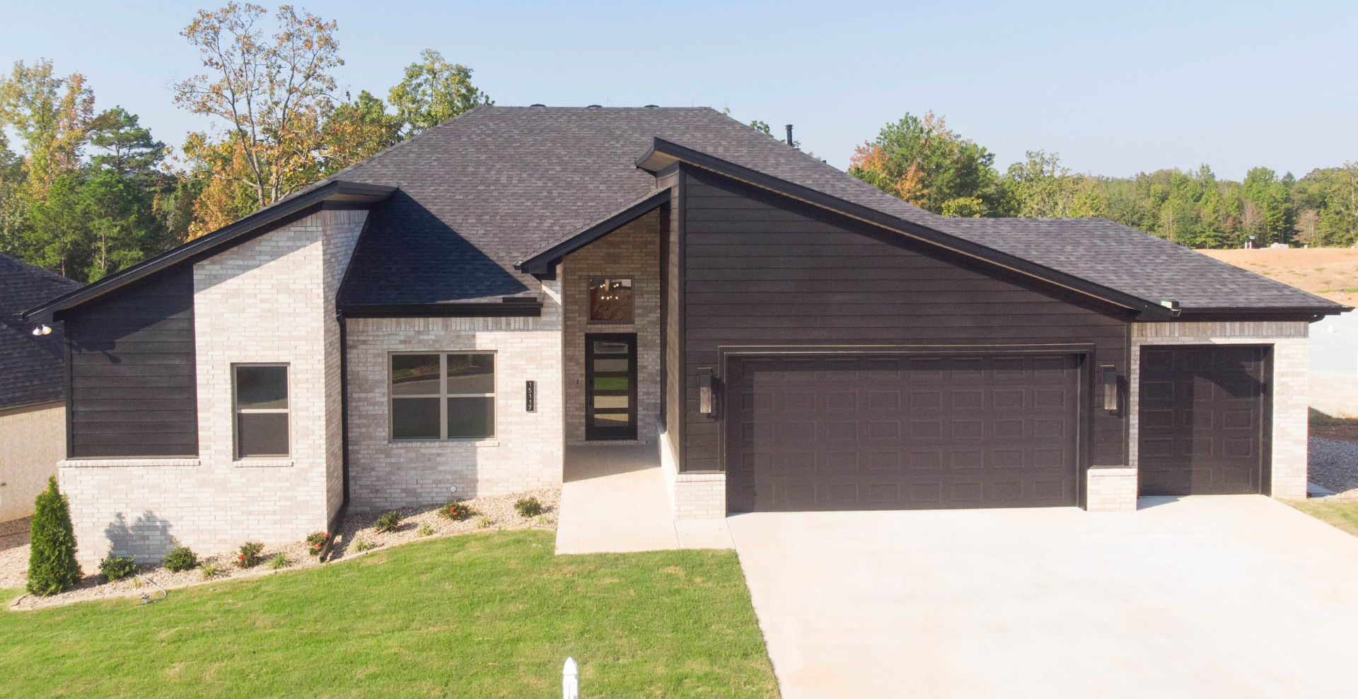 new construction home that is two story and lighter exterior colors. full of windows for natural light