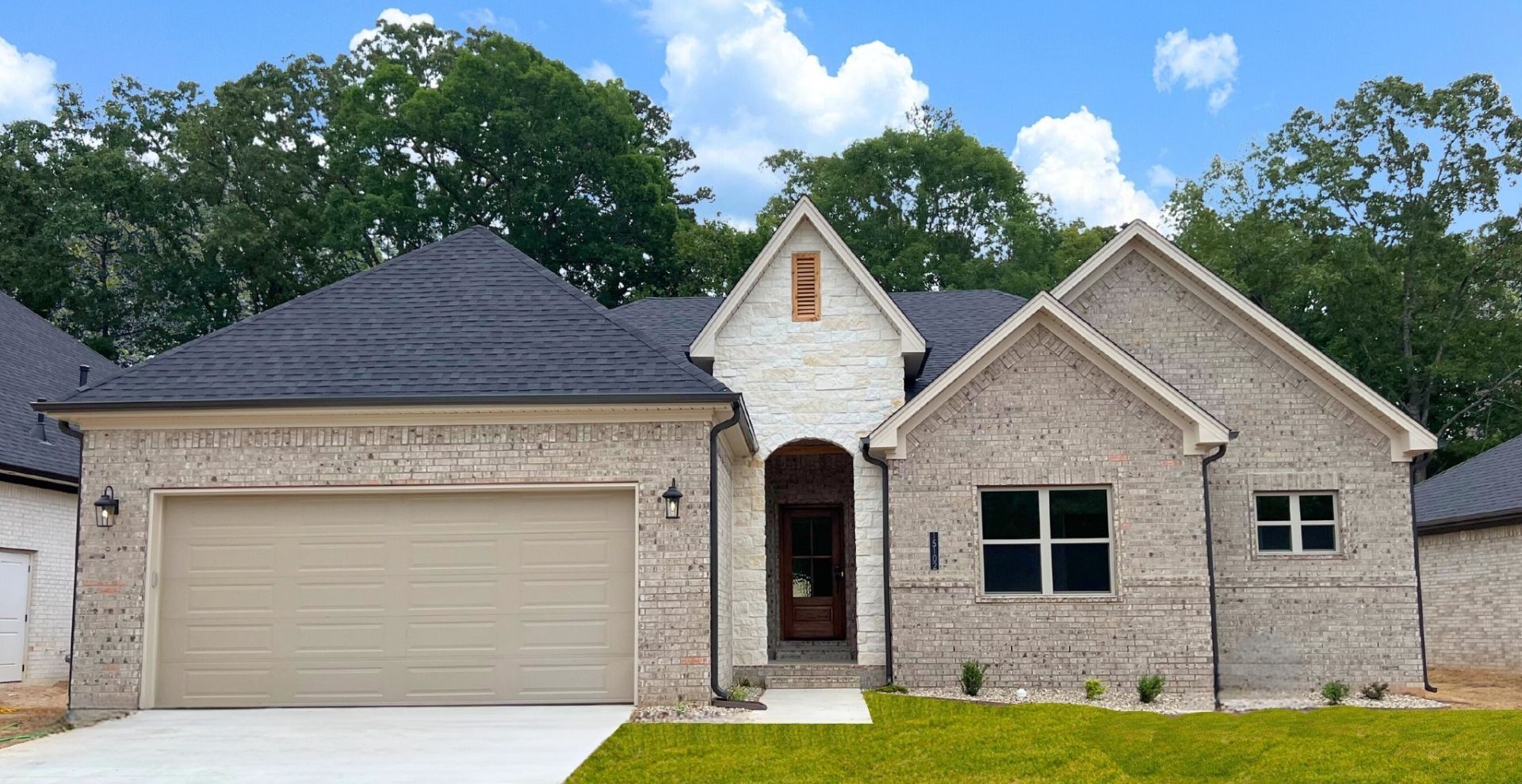 new construction home in maumelle arkansas with lighter brick and beige garage door