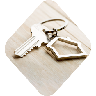 Photo of keys with a house keychain, all encapsulated in a diamond shape