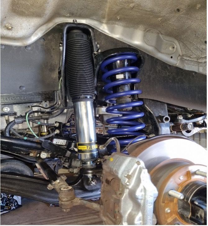 A Close Up Of A Car Suspension With A Tyre In The Background — Valley Brake & Clutch In McDougalls Hill, NSW