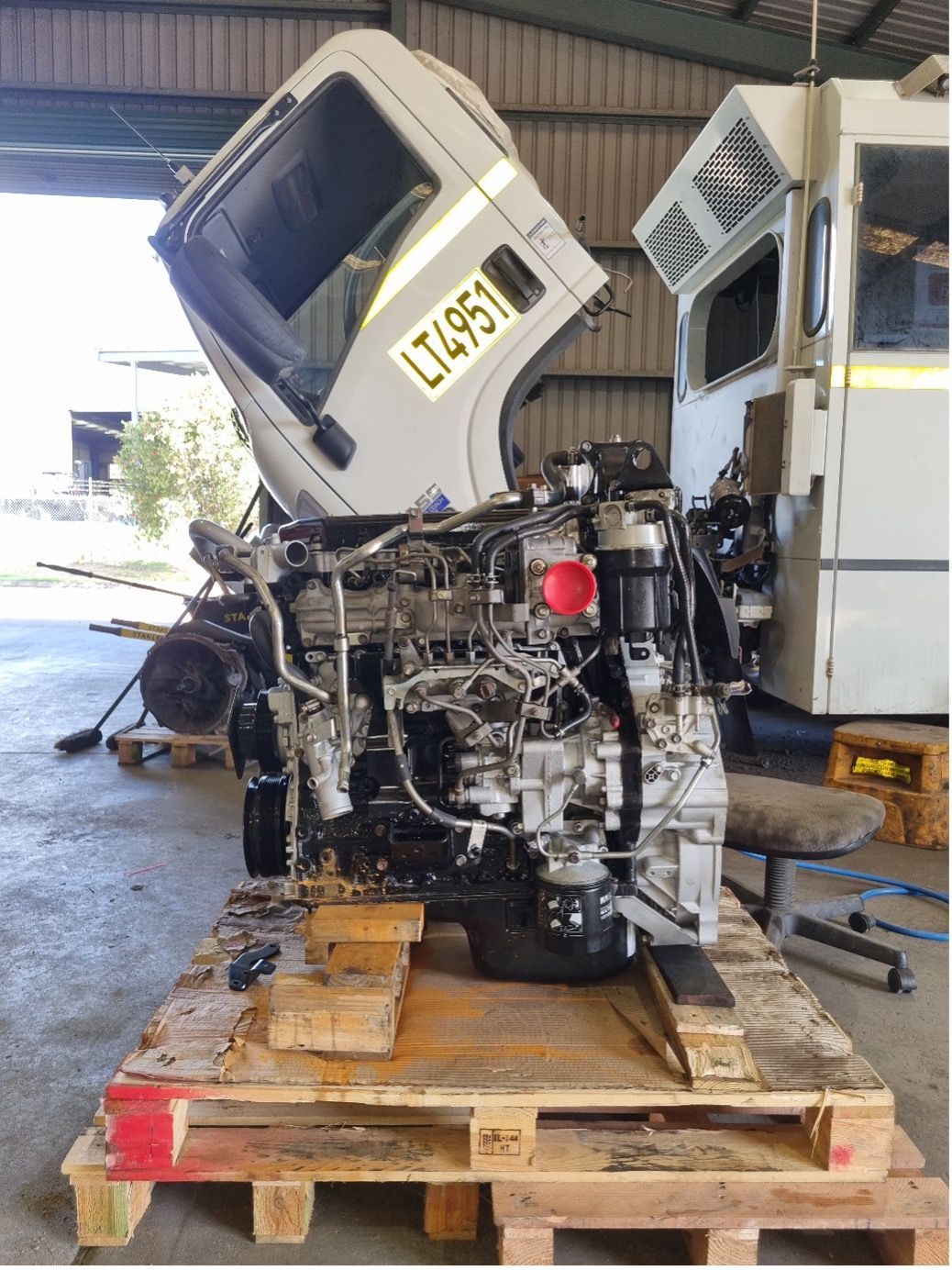 A Truck Engine is Sitting on a Wooden Pallet in a Garage — Valley Brake & Clutch In McDougalls Hill, NSW