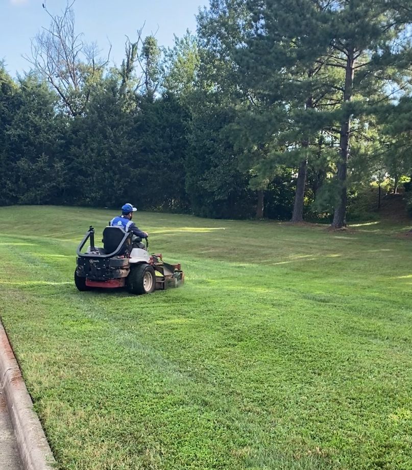 Commercial lawn mowing services in Northern Virginia performed by GreenWish crew using professional equipment on a maintained commercial property.