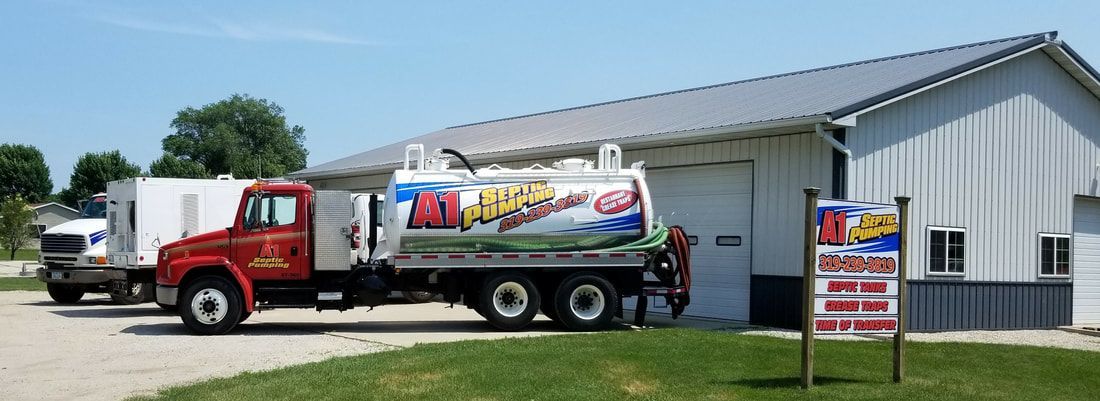 a septic pumping truck is parked in front of a building