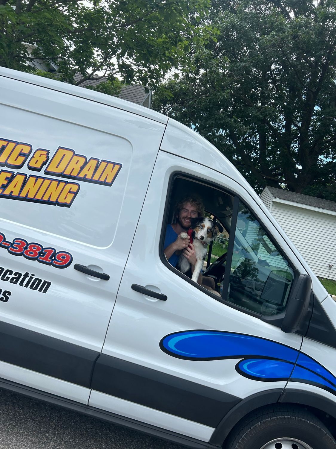 a man wearing a shirt that says ' drain cleaning ' on it