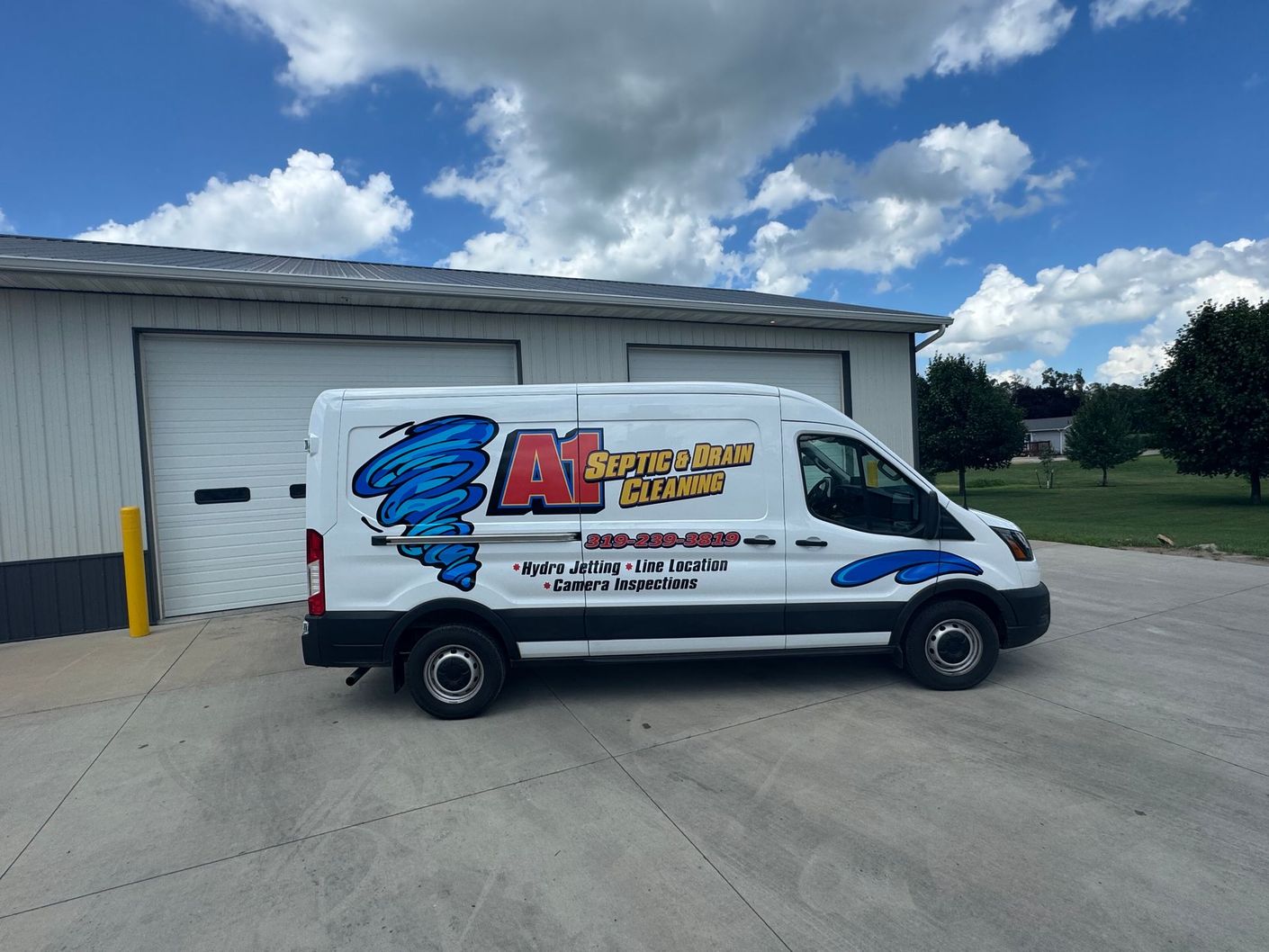 a septic pumping truck is parked in front of a building