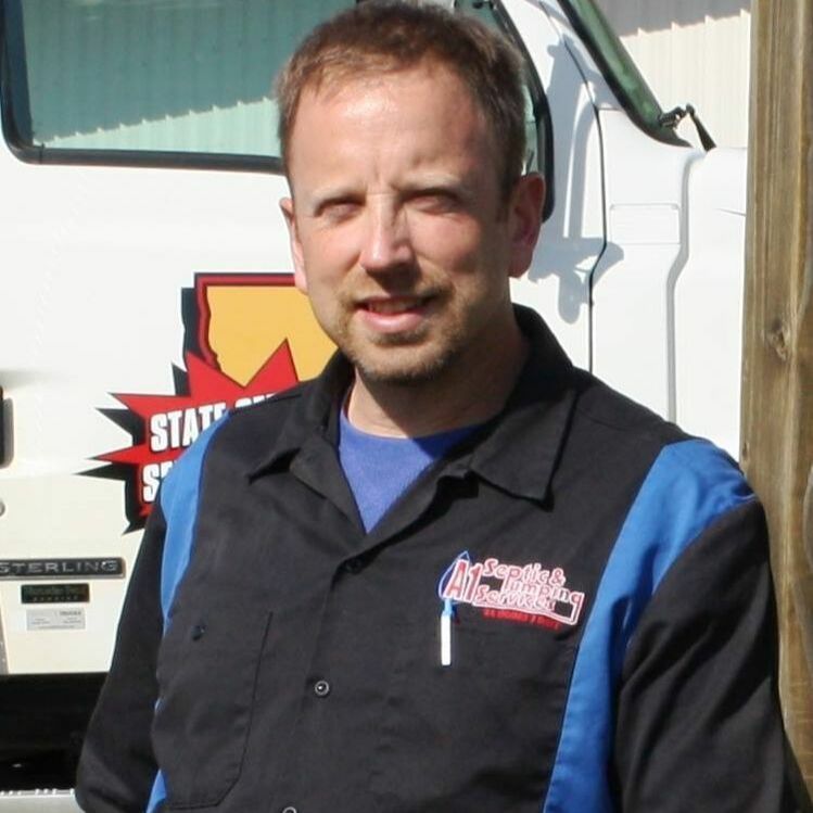 a man standing in front of a sterling truck