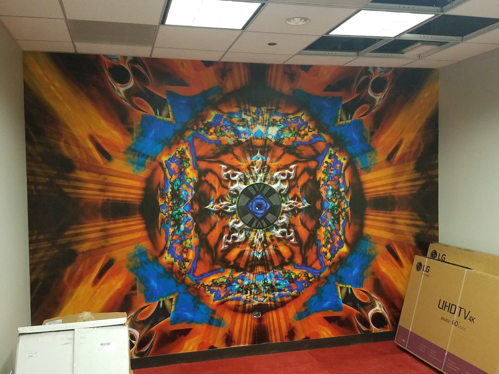 A room with a large colorful painting on the wall