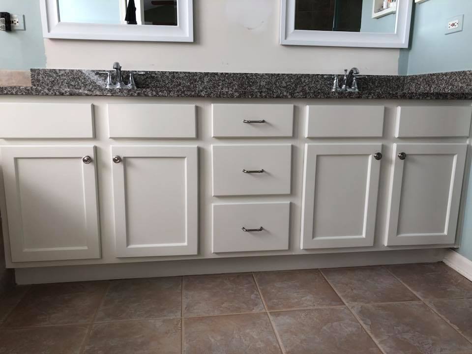 A bathroom with two sinks and two mirrors