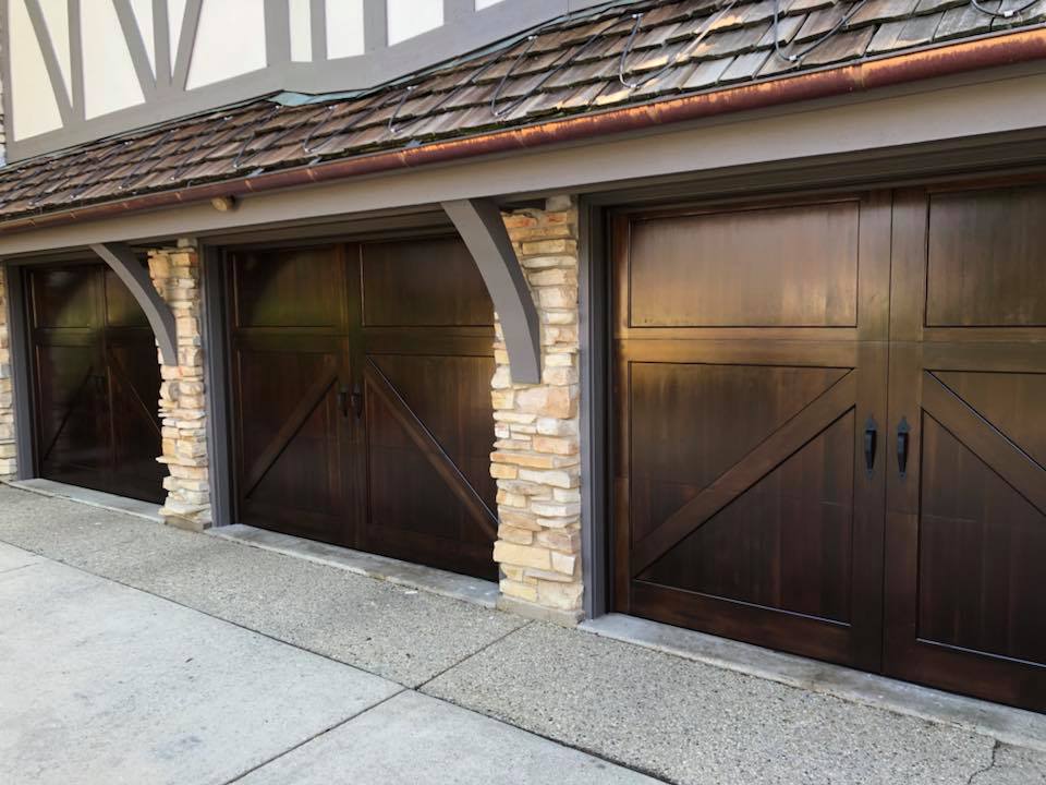 A row of wooden garage doors on the side of a building