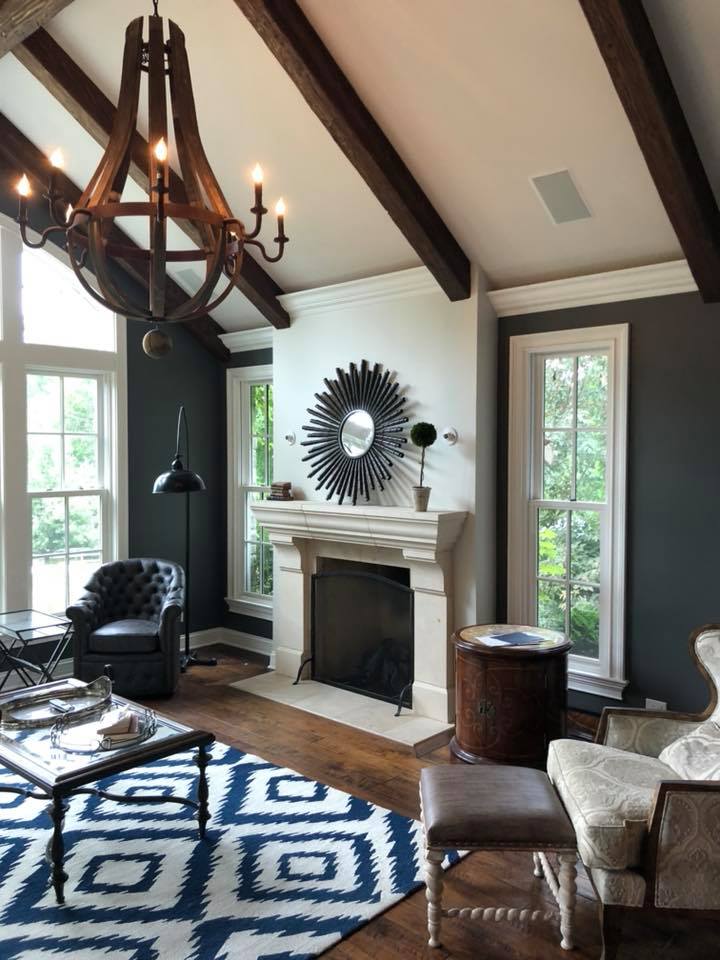 A living room with a fireplace and a chandelier