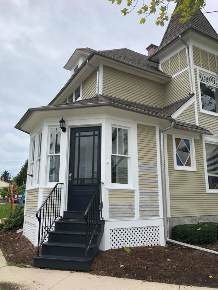 A house with stairs leading up to the front door