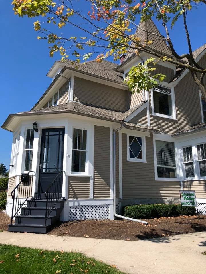 A house with stairs leading up to the front door