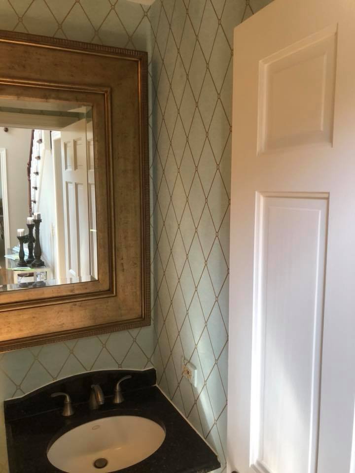 A bathroom with a sink and a mirror on the wall